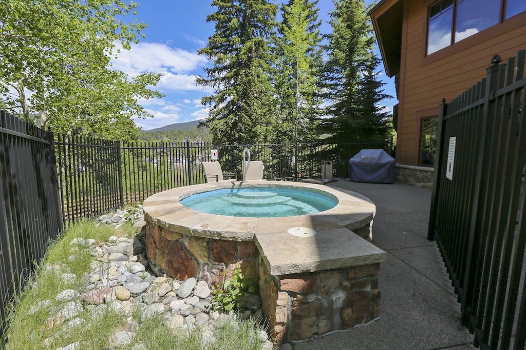 Soak in your private hot tub surrounded by towering evergreens and mountain views for the ultimate relaxation retreat.