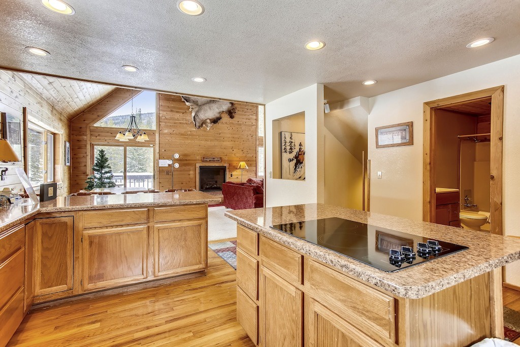 Your fully equipped kitchen features granite counters and gleaming appliances, perfect for creating memorable meals during your mountain getaway.