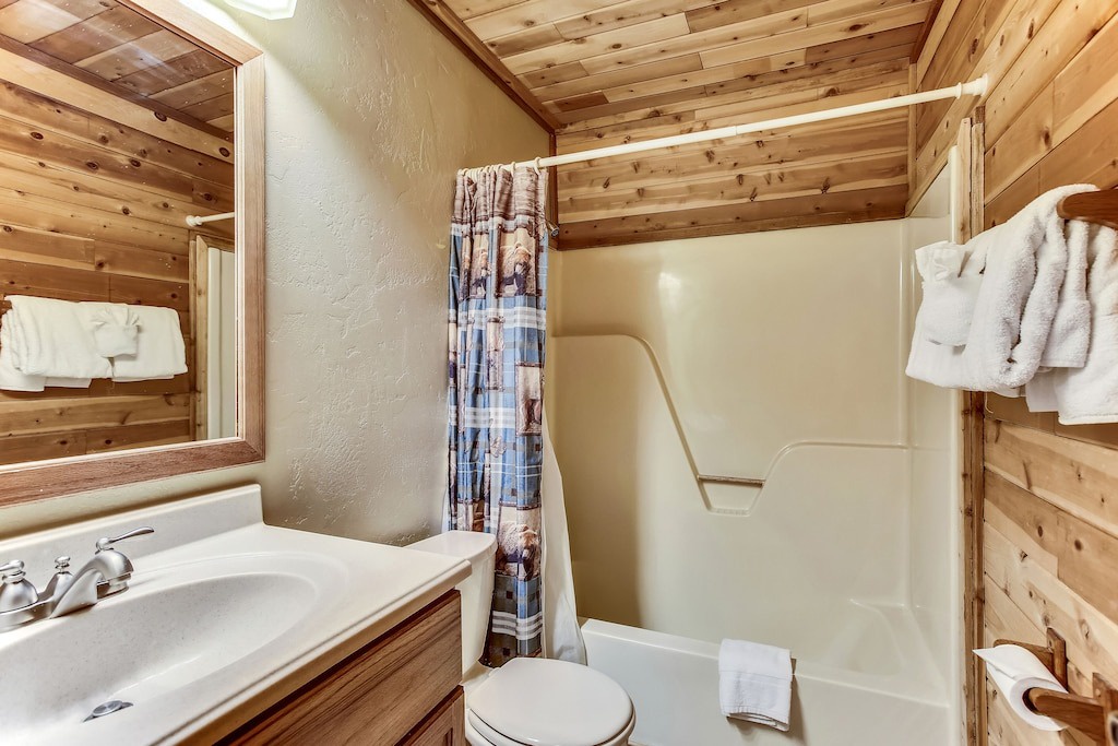 Unwind in your cozy cabin bathroom featuring warm wood beams, fresh towels, and rustic charm for a perfect mountain retreat experience.