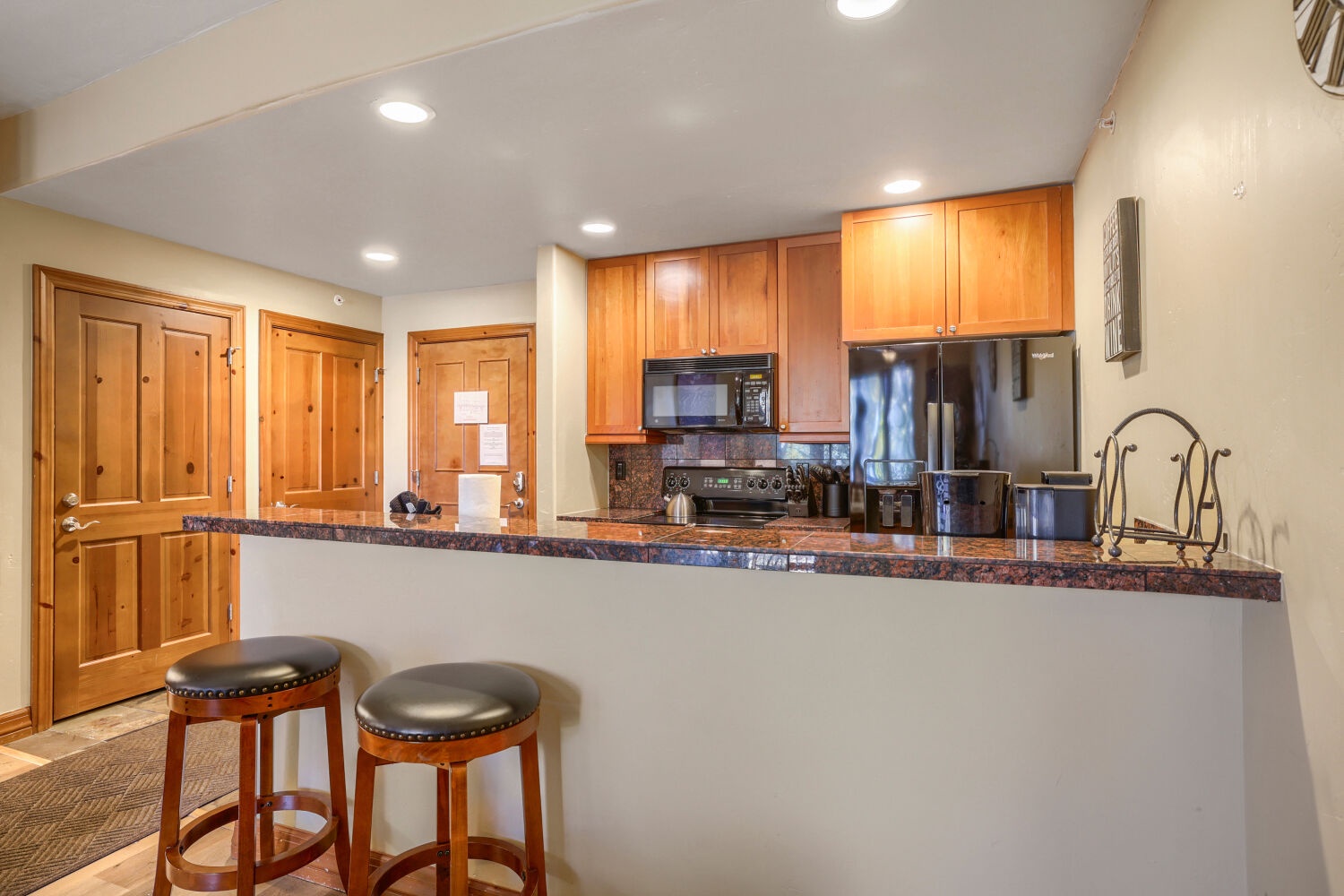 Your fully equipped kitchen awaits with granite counters, stainless steel appliances, and a breakfast bar—perfect for morning coffee or preparing meals together after a day of adventure.