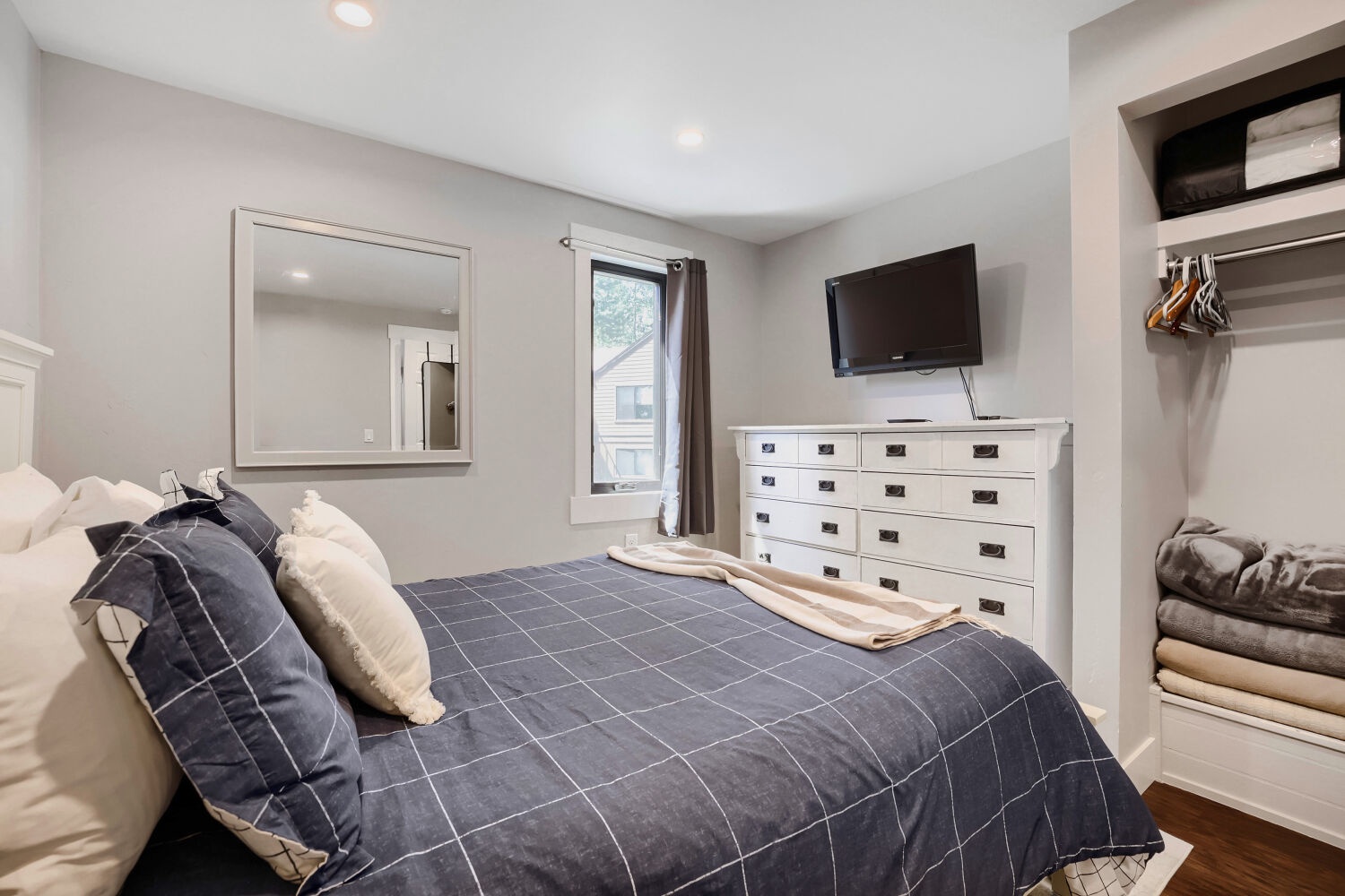 Unwind in your cozy bedroom, where a plush bed, modern TV, and ample storage create the perfect retreat after a day of exploring.