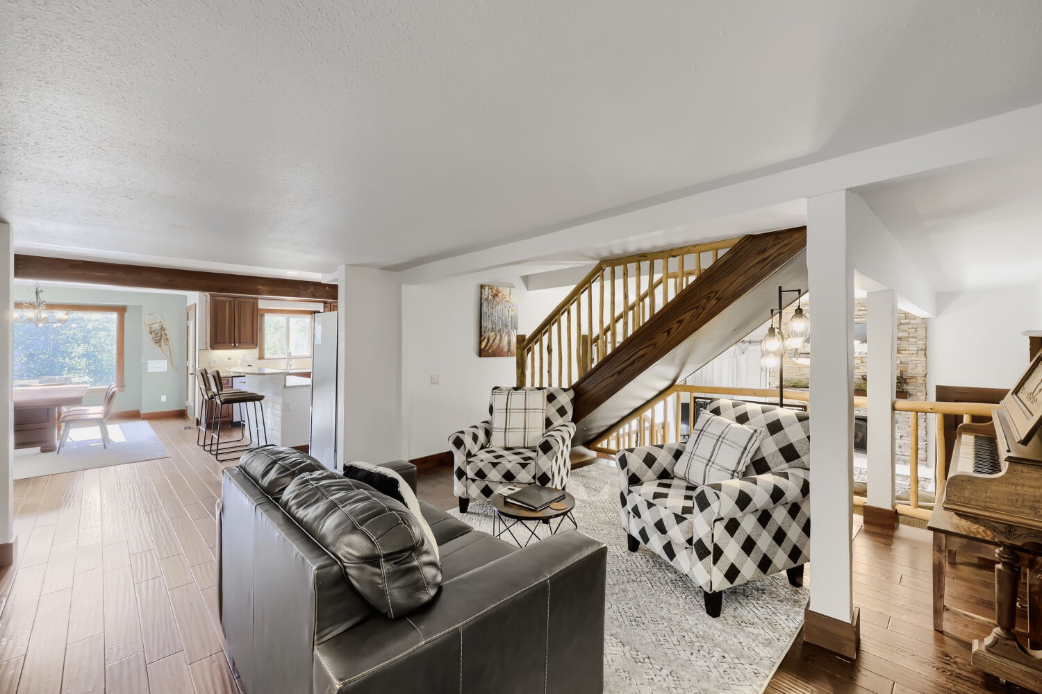 Gather with loved ones in this bright, open living room, where plush seating and warm wood tones invite you to relax and feel right at home.