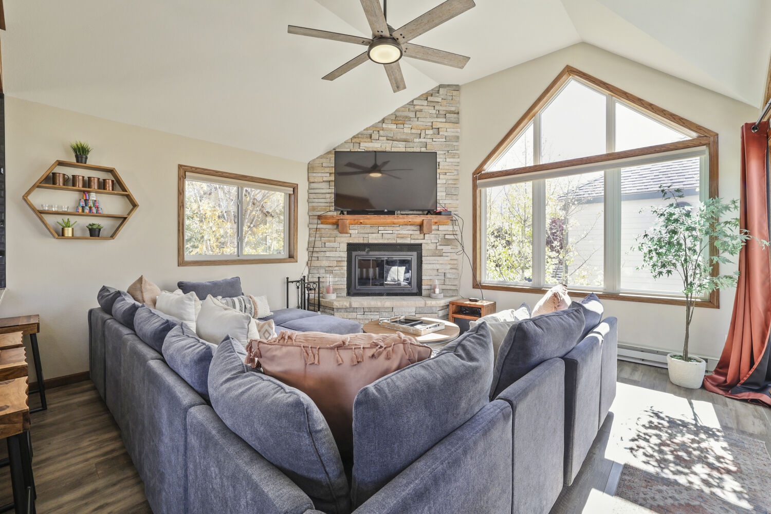 Settle into plush seating by your own stone fireplace, where natural light floods through vaulted windows and mountain breezes drift in. This is where your mornings begin and evenings unwind.