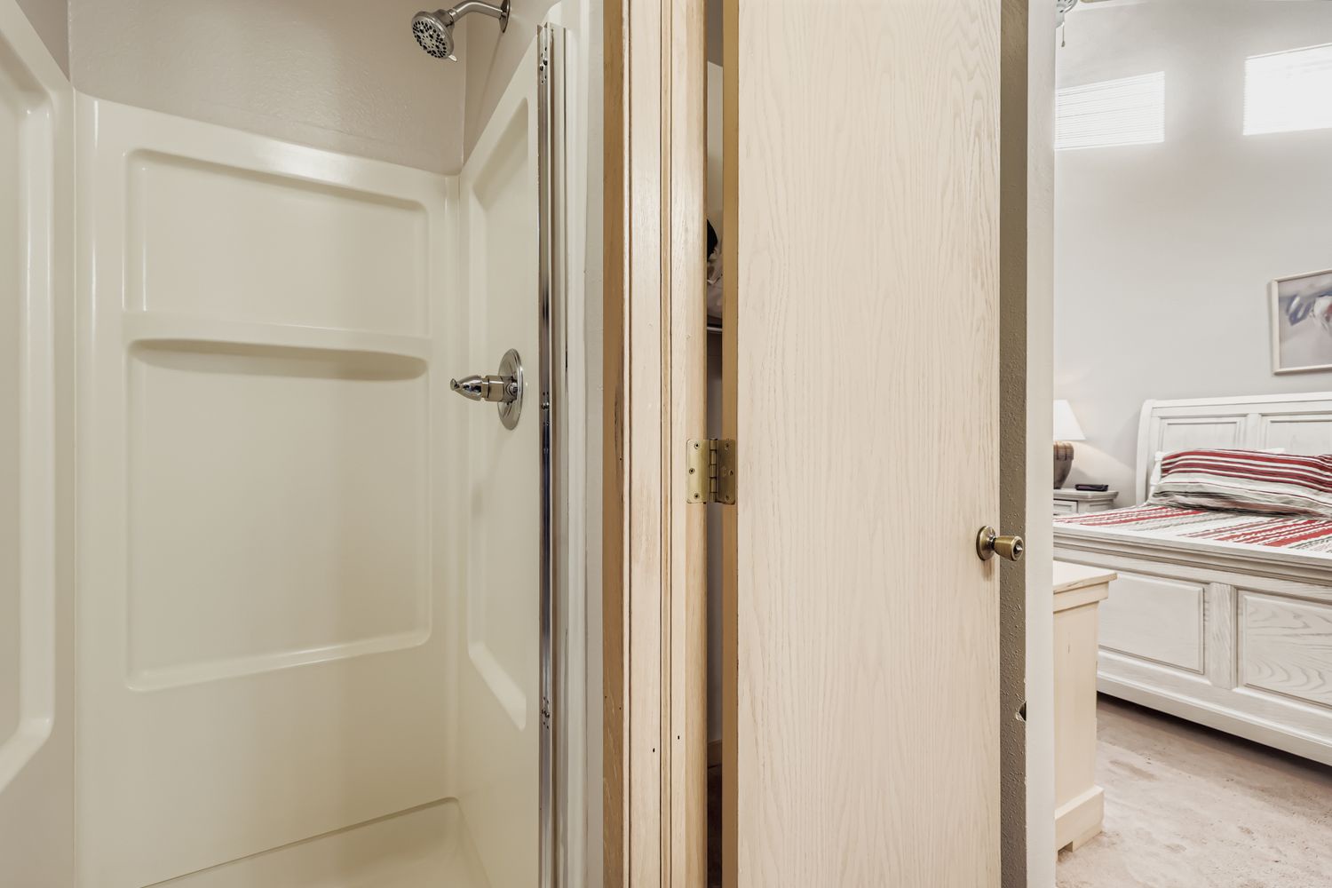 Step into your private en-suite with a pristine walk-in shower featuring built-in shelving for your toiletries.