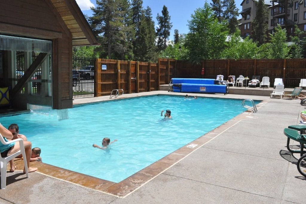 Dive into crystal-clear waters in this inviting outdoor pool area, where you can soak up sunshine and unwind in a peaceful setting.