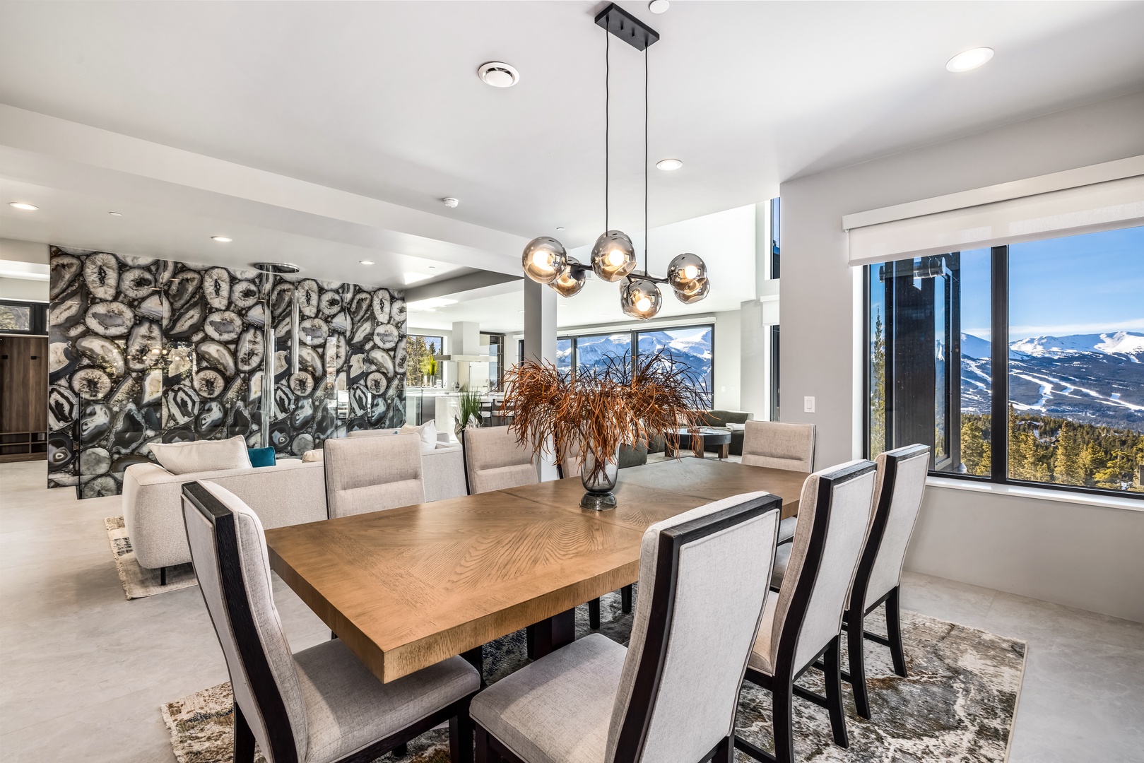 Gather around this stunning dining table where mountain views frame every meal in your luxurious retreat.
