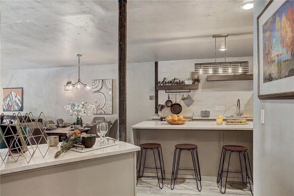 Your modern kitchen features rustic beams, marble counters, and cozy breakfast bar seating—perfect for morning coffee or preparing meals together.
