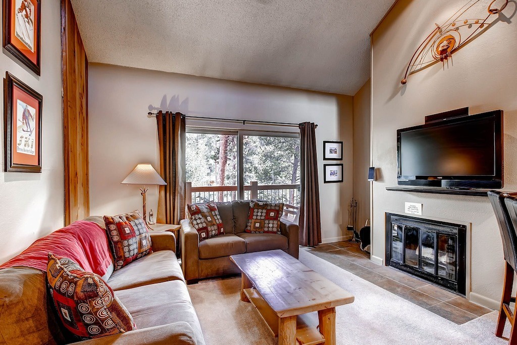 Cozy up by your crackling fireplace while watching the flat-screen TV, surrounded by warm wood accents and forest views.