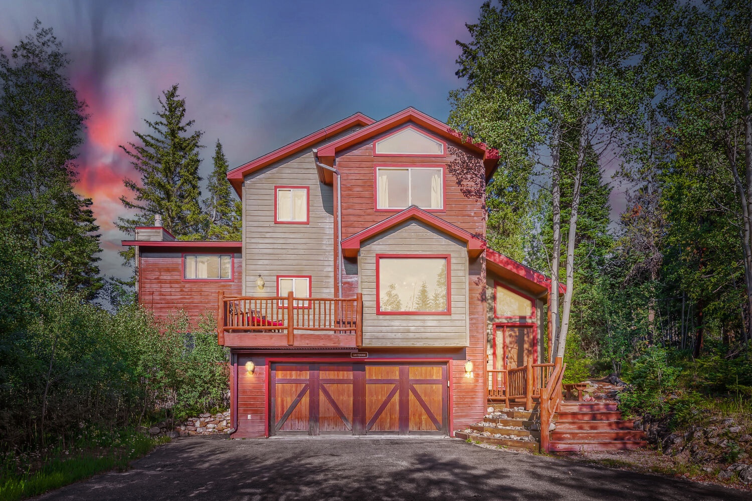 A charming mountain retreat nestled among towering pines, featuring warm wood tones, spacious decks, and garage parking in a peaceful forested setting.