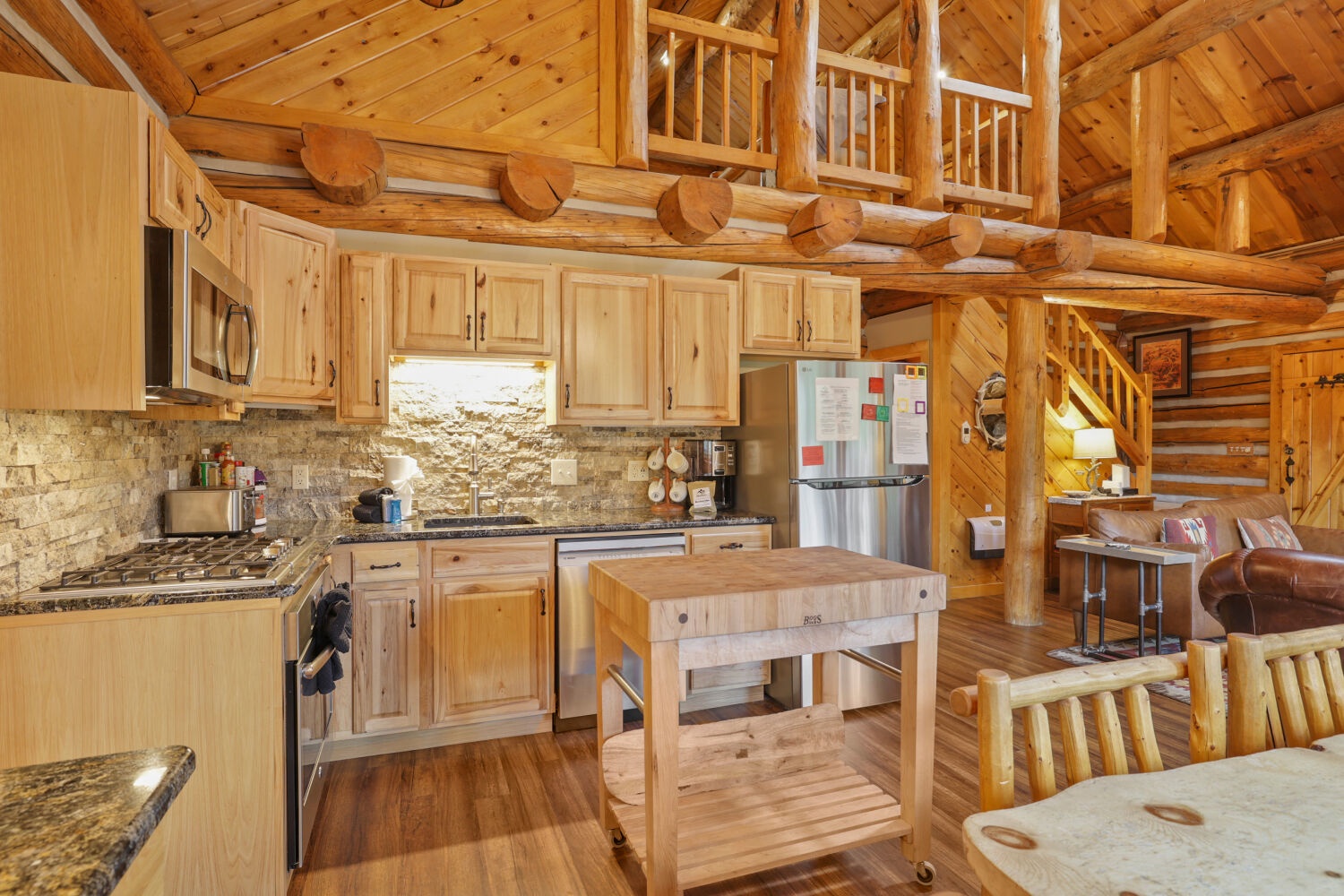 Step into your rustic mountain retreat, where warm wood surrounds you from floor to ceiling. Cook in a fully equipped kitchen with a handy island, then gather around the cozy living area under soaring timber beams and a charming loft.