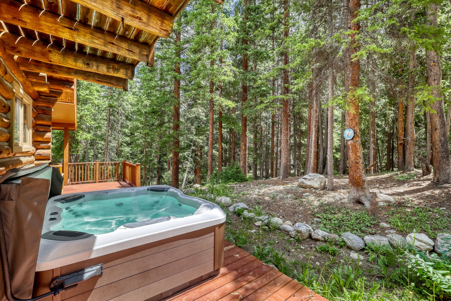 Soak in your private hot tub surrounded by towering pines and fresh mountain air—a peaceful forest escape just steps from your cabin.