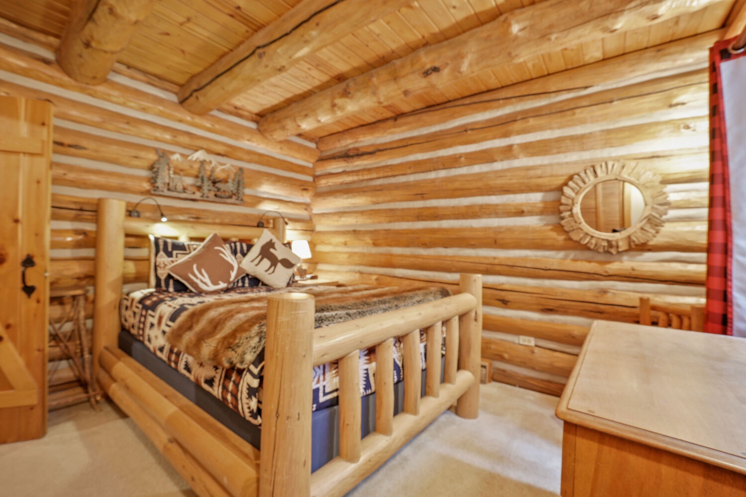 Cozy up in your warm log cabin bedroom with rustic wood beams and inviting décor that wraps you in mountain charm.
