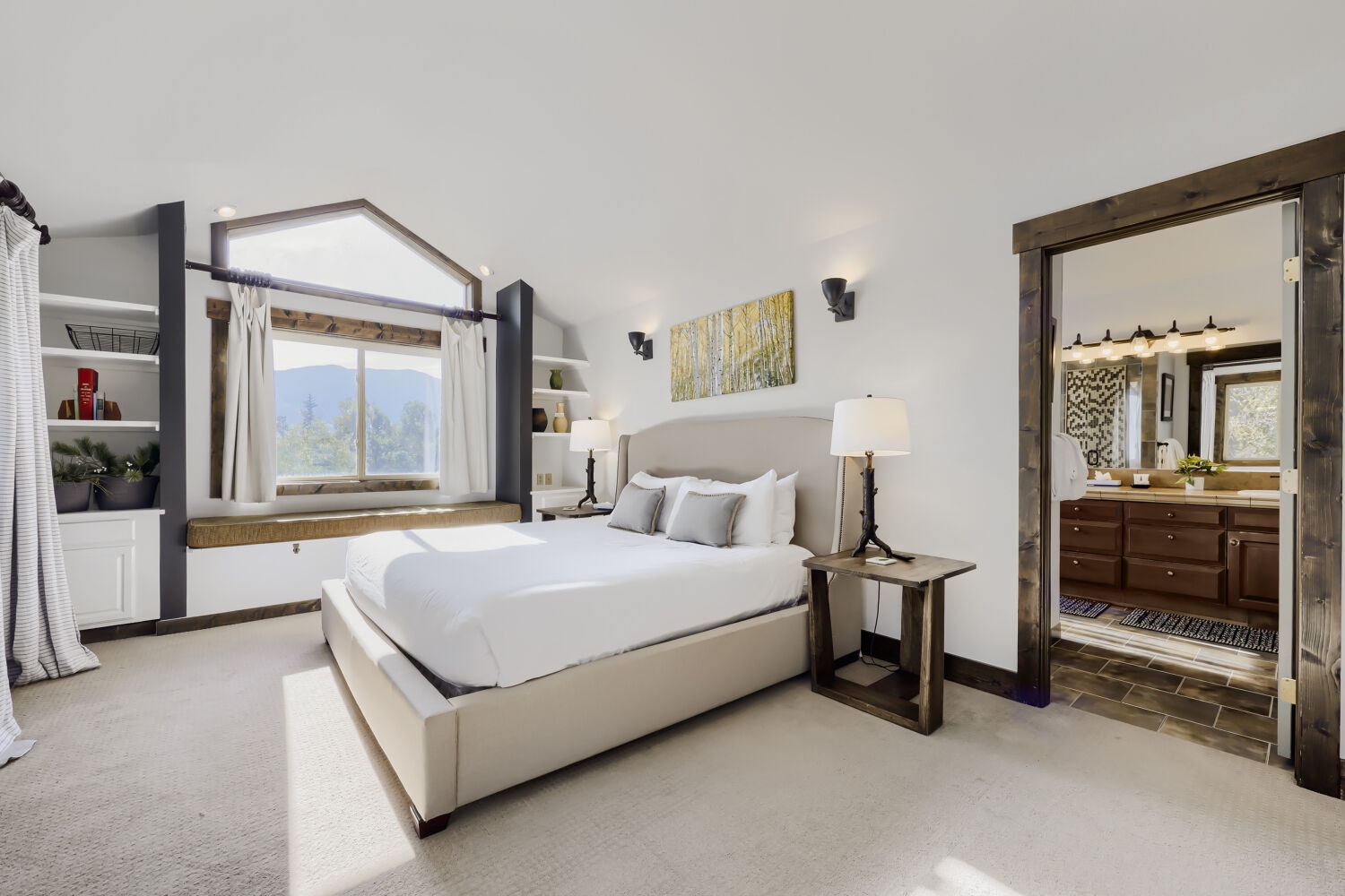 Wake up to mountain views framed by charming rustic woodwork in your serene bedroom retreat. Crisp linens and natural light create the perfect escape for rest and relaxation.