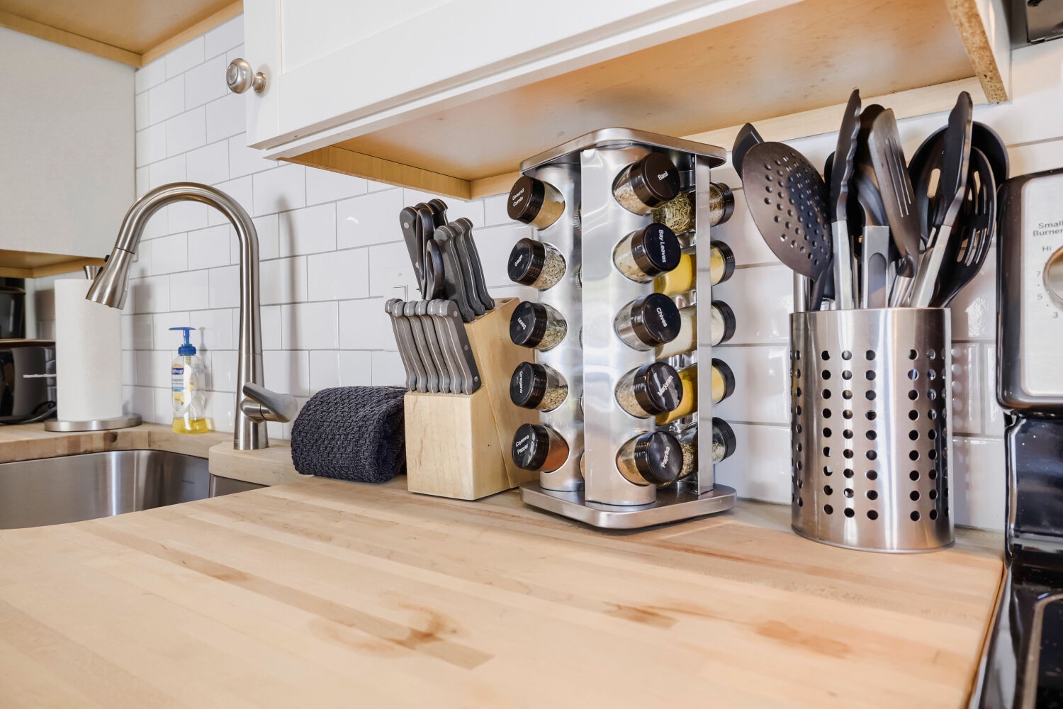 You'll love preparing meals on these beautiful butcher block counters, outfitted with quality knives, utensils, and spices—everything you need at your fingertips.