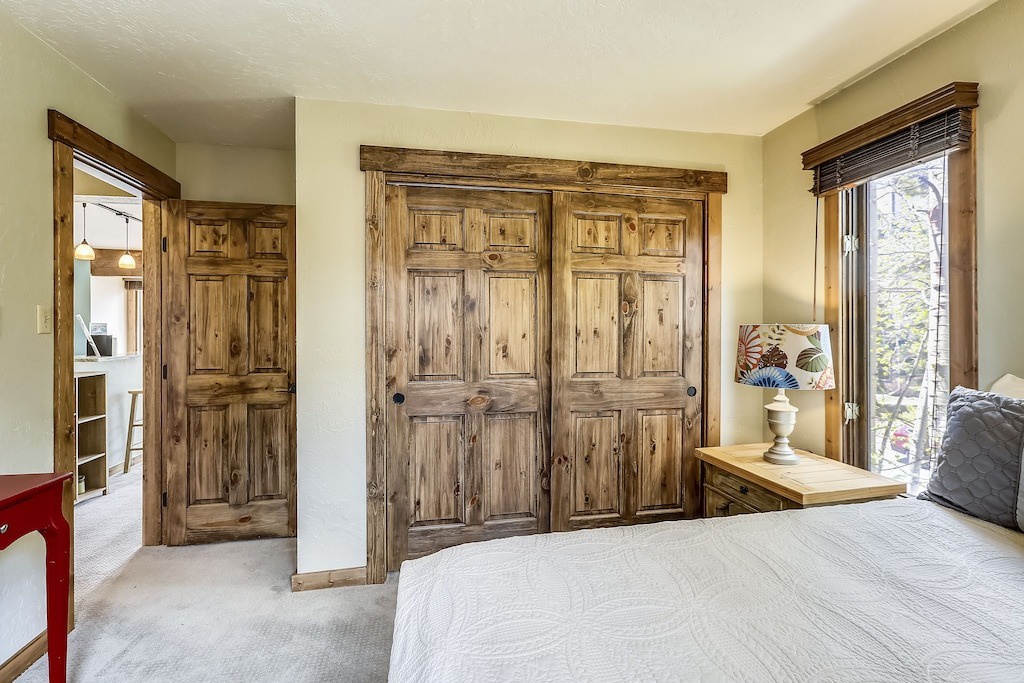 Your cozy bedroom features beautiful rustic wood wardrobes and charming rustic details throughout.