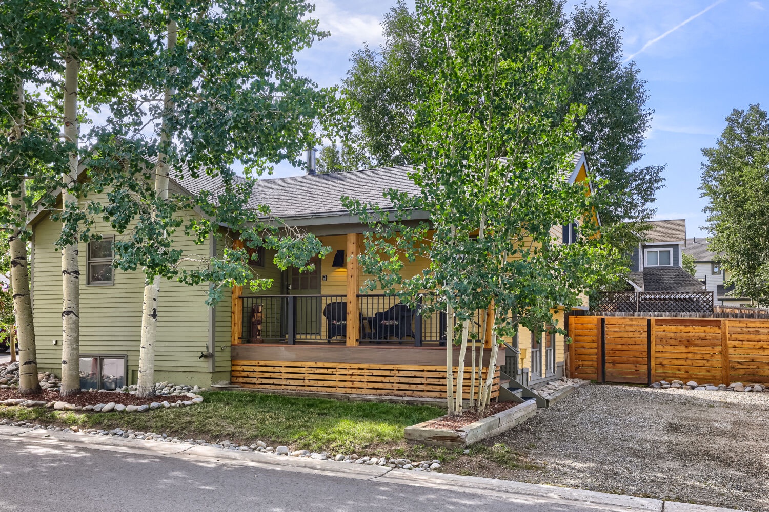 A charming mountain home with warm wood accents and a spacious deck surrounded by mature aspens—a peaceful retreat with natural beauty and easy access.