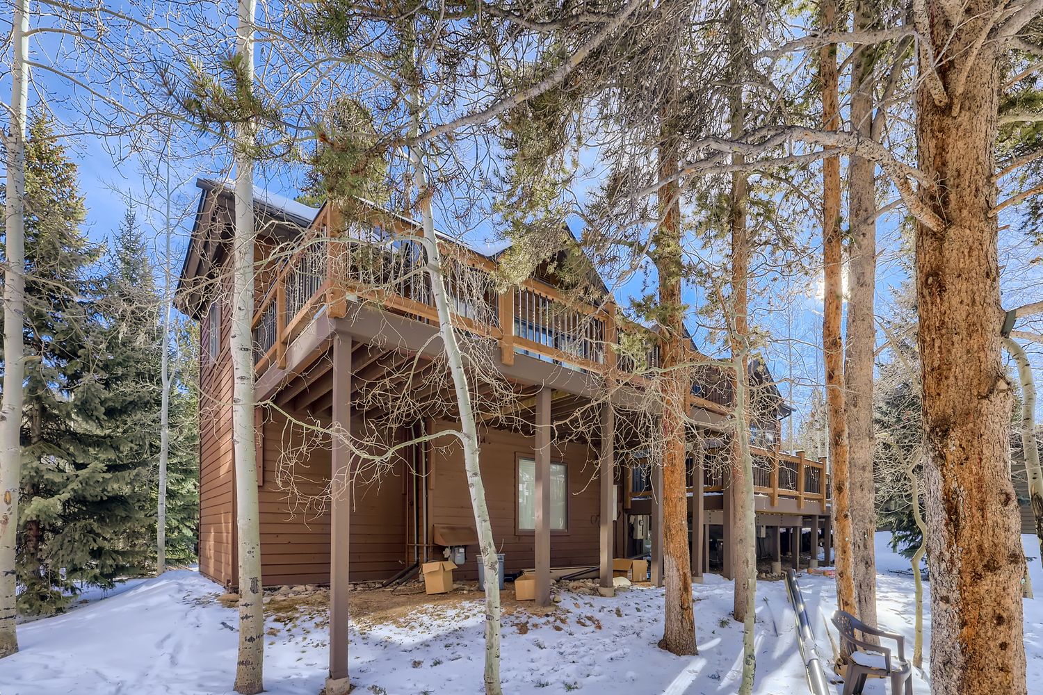 Charming mountain cabin nestled among towering pines, with a welcoming deck where you can breathe in crisp alpine air.