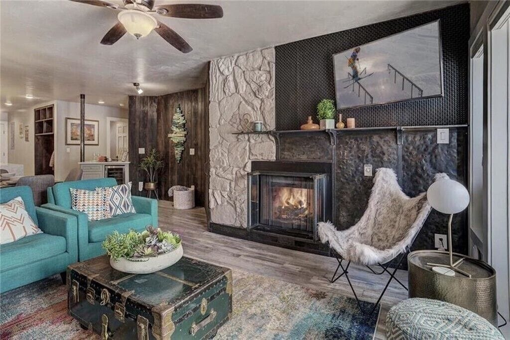 Cozy up by the crackling fireplace with stylish seating and modern touches for your perfect mountain getaway.