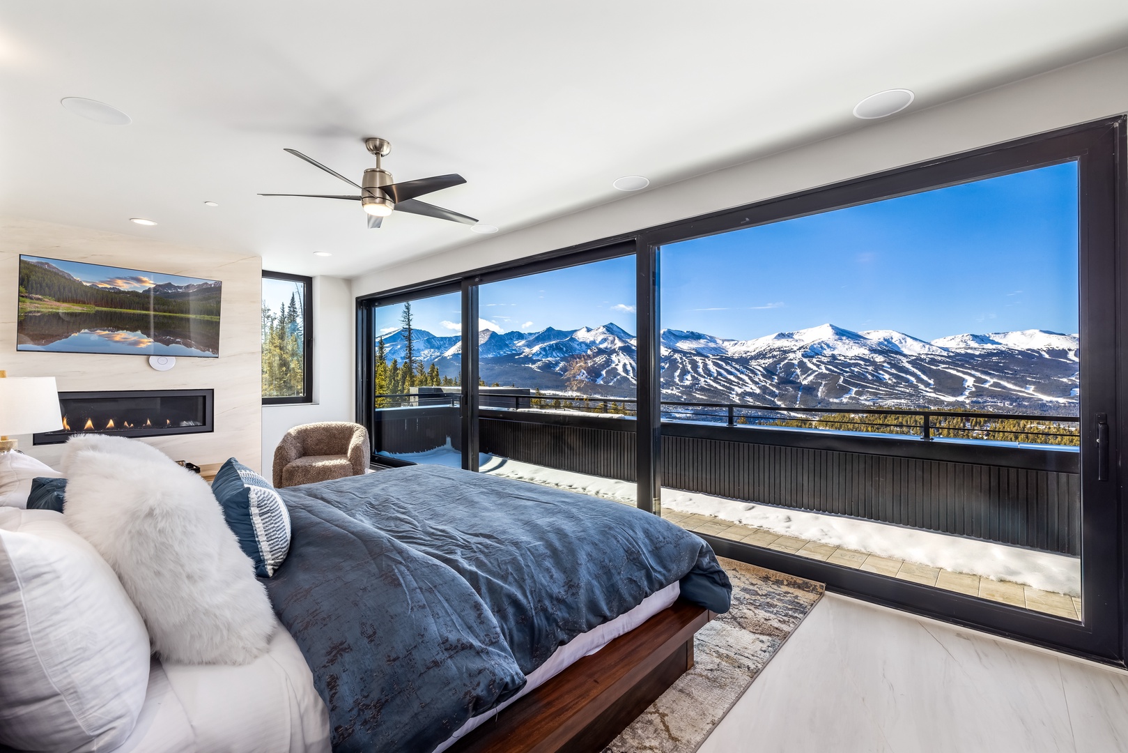 Wake up to breathtaking mountain views through floor-to-ceiling windows. Your cozy fireplace and luxurious bedding create the perfect alpine retreat.