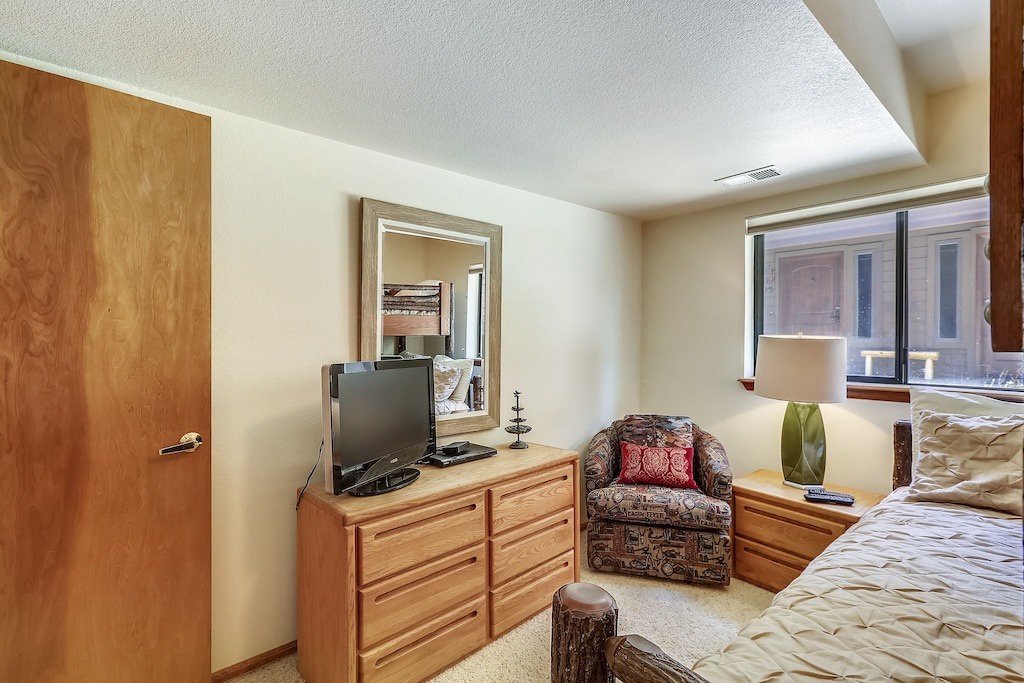 Unwind in your cozy retreat with warm wood furnishings, comfortable seating, and mountain views from your window.