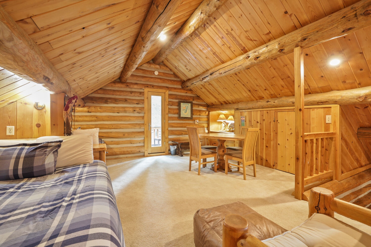 Warm wood beams and cozy furnishings create a rustic retreat where you can unwind after a day of adventure. Natural light fills this inviting space, perfect for gathering with loved ones.