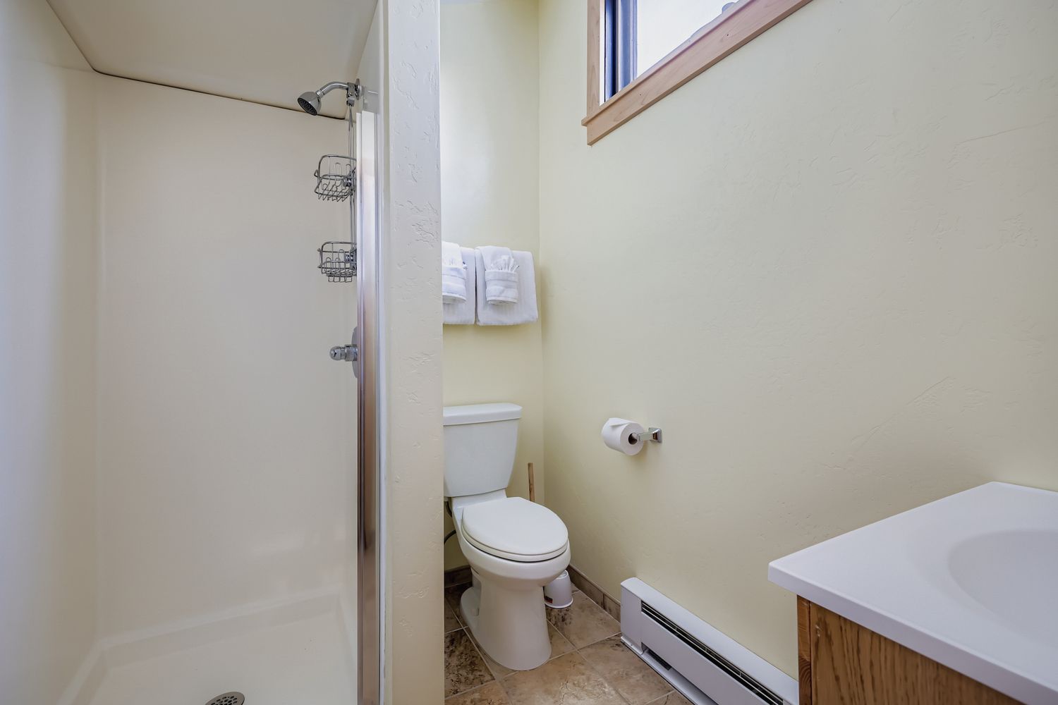 Your private bathroom offers everything you need with a convenient walk-in shower and fresh towels waiting for you.