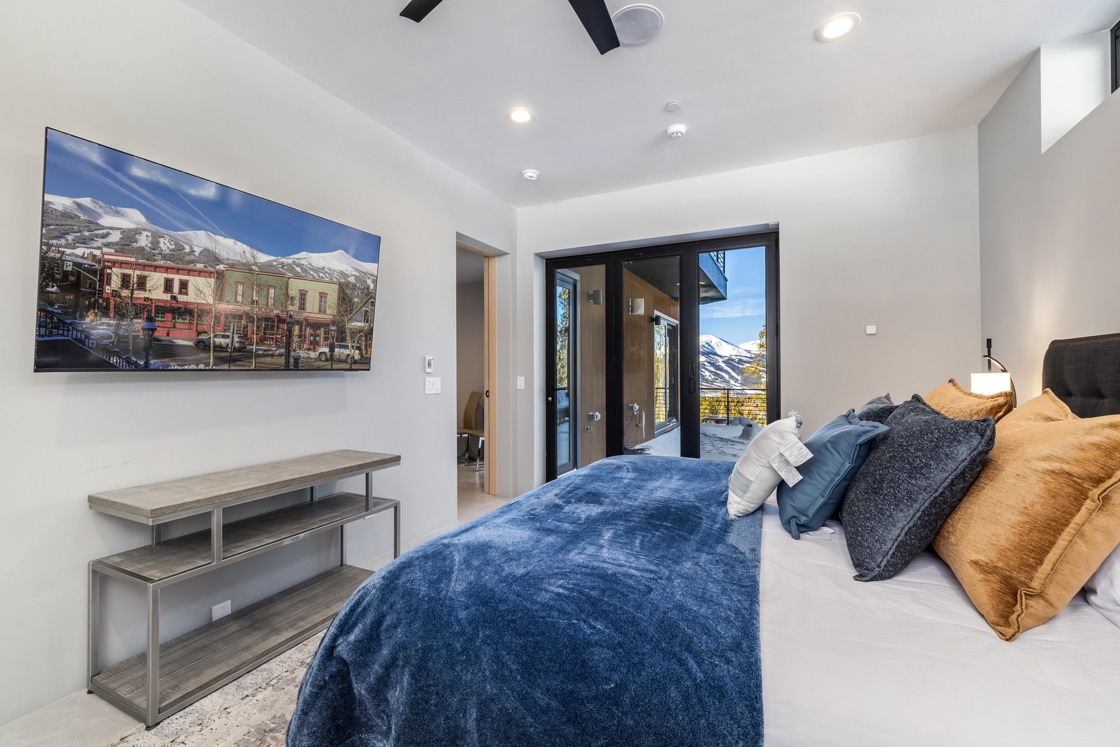 Sink into luxurious bedding while enjoying stunning mountain views through your private balcony doors. Your spacious room features modern amenities and serene atmosphere.