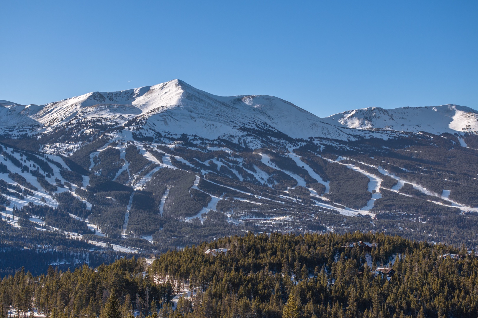 Majestic snow-covered peaks and pristine ski slopes create a stunning mountain backdrop for winter adventures.