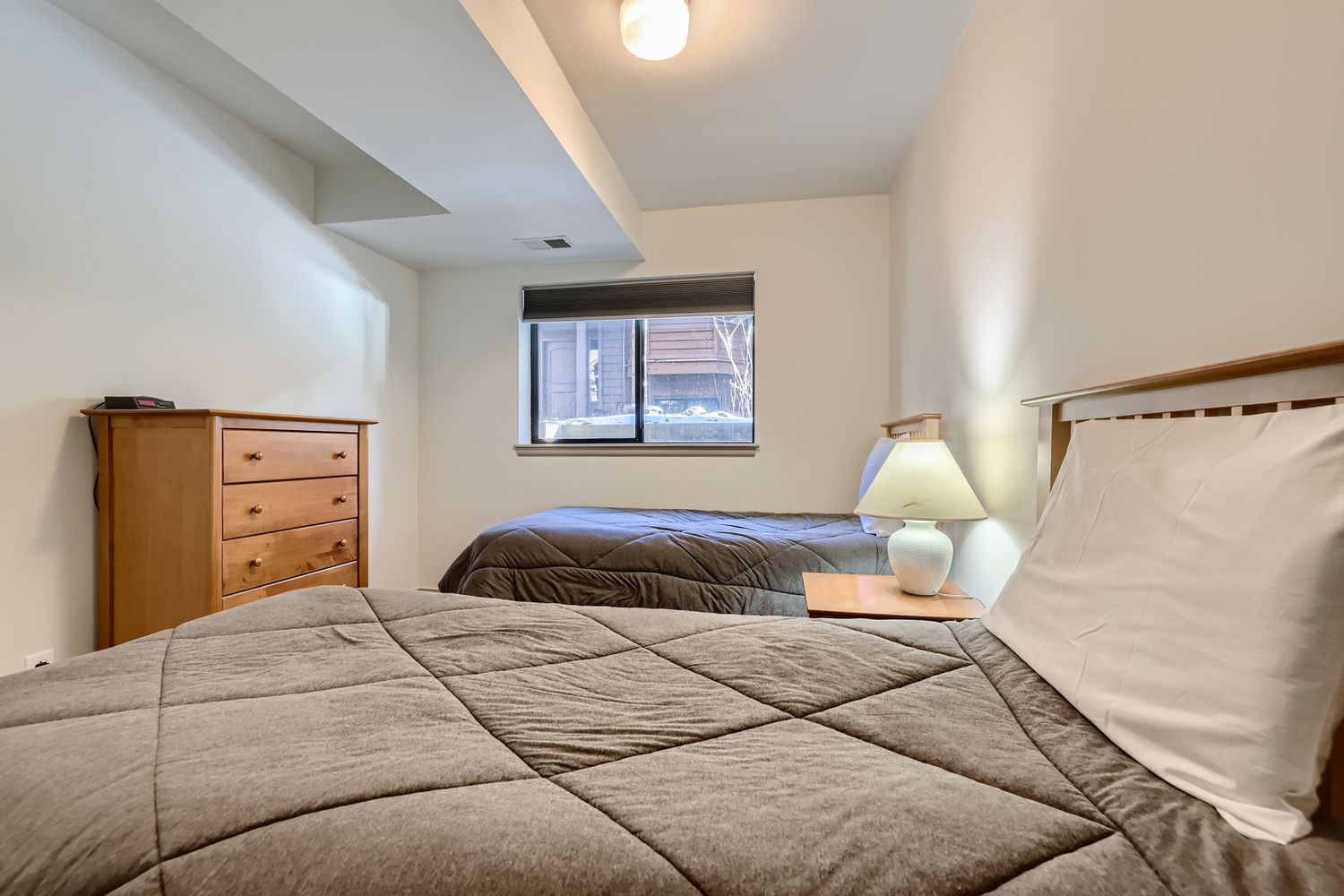 Rest peacefully in your cozy twin bedroom with soft linens, warm lighting, and thoughtful touches that make you feel right at home.