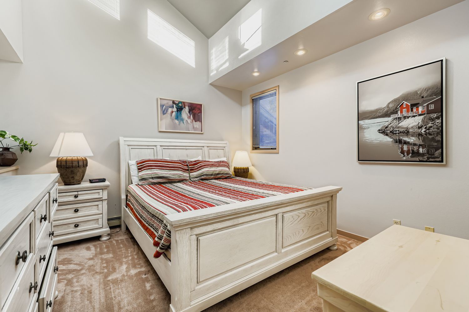 Sink into your cozy bedroom retreat with crisp linens, warm lighting, and charming artwork creating the perfect peaceful escape.