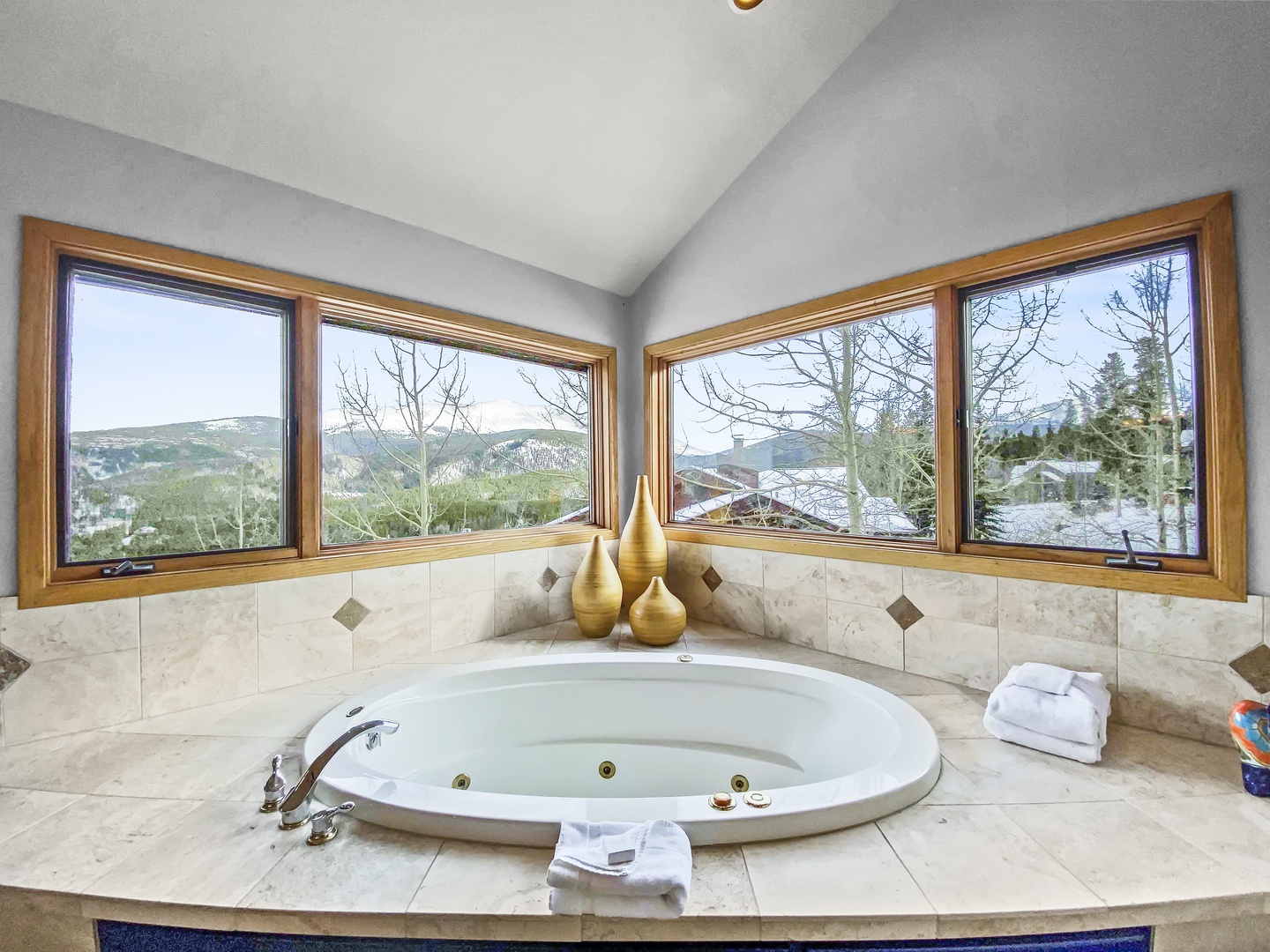 Soak away your cares in this spacious corner jetted tub surrounded by sweeping mountain vistas through floor-to-ceiling windows—your private retreat after a day exploring the slopes.