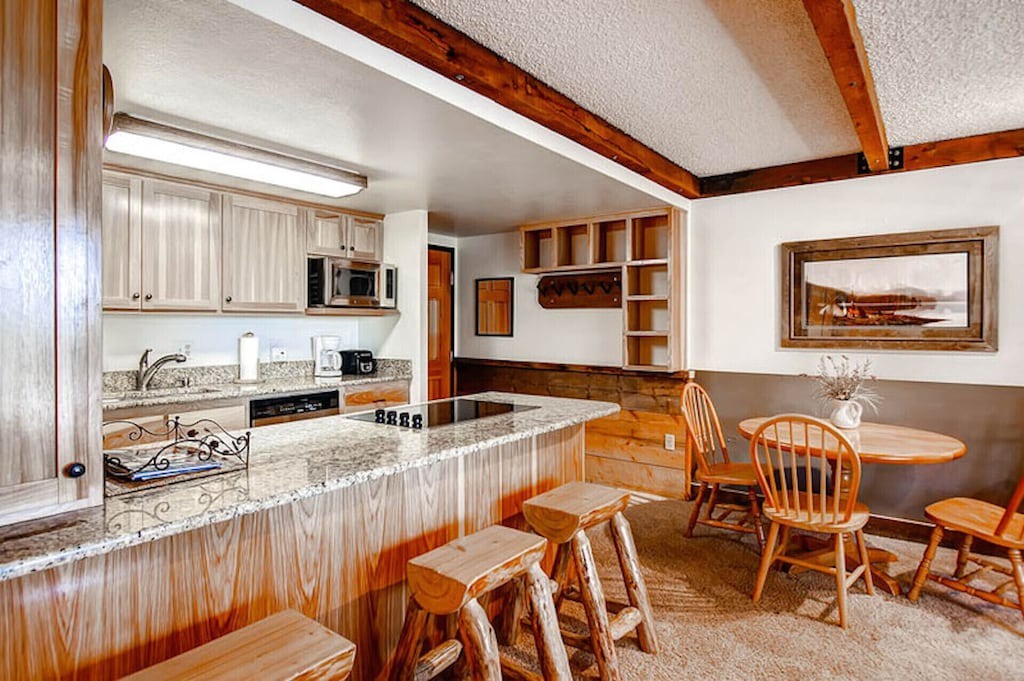 You'll love preparing meals in this charming rustic kitchen, complete with granite counters and cozy dining nook.