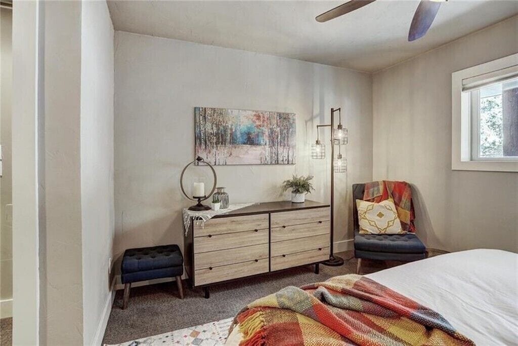 Sink into your stylish bedroom retreat with mid-century modern furnishings and warming autumn-colored textiles creating the perfect cozy atmosphere.