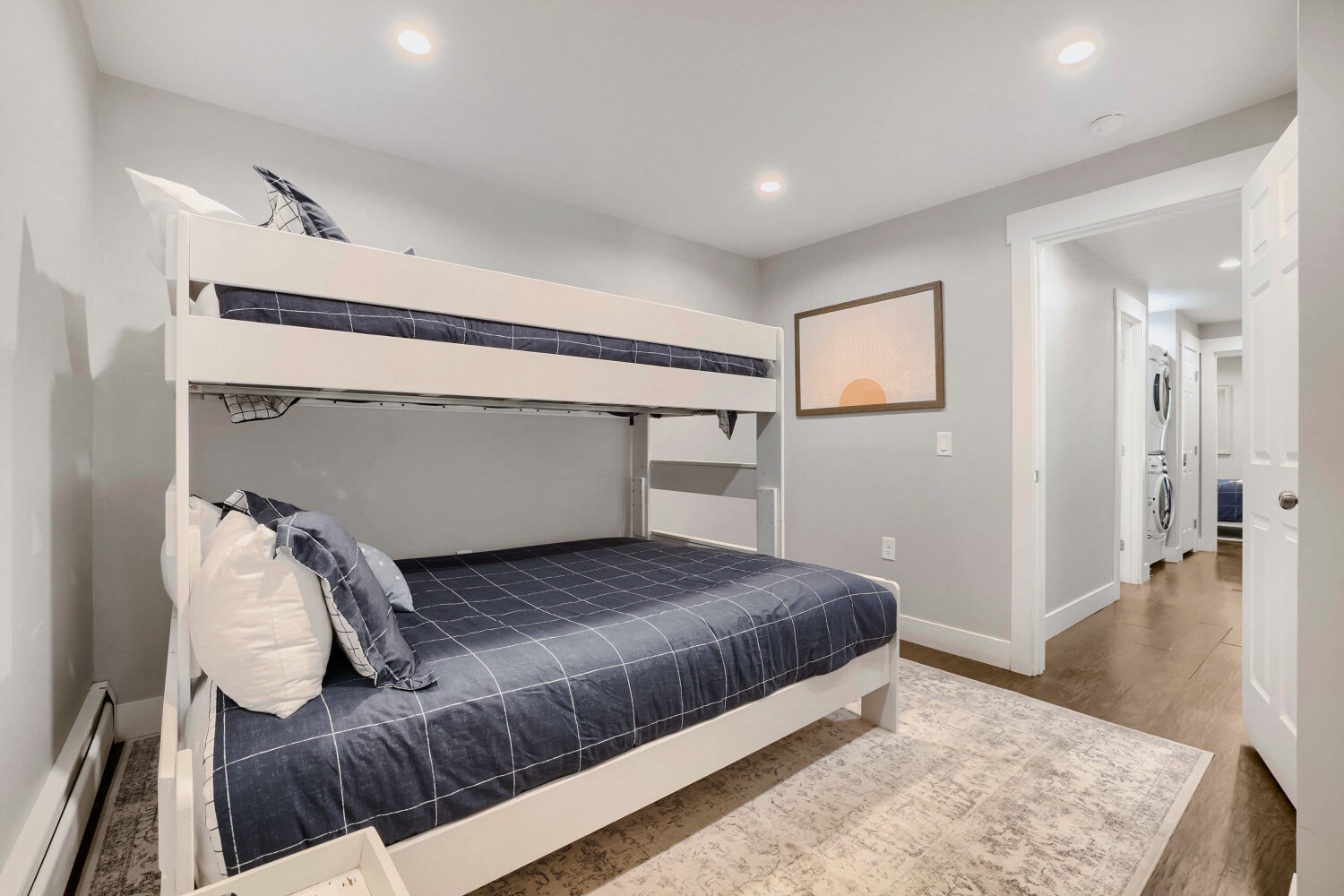 Your group will rest easy in this cozy bedroom featuring sturdy bunk beds dressed in crisp navy linens—perfect for kids or friends sharing space.
