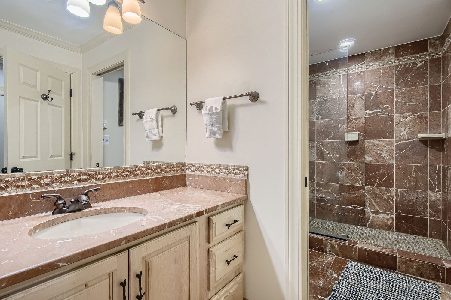 Luxurious marble bathroom featuring elegant countertops and a stunning tiled shower where you'll enjoy your daily refresh.