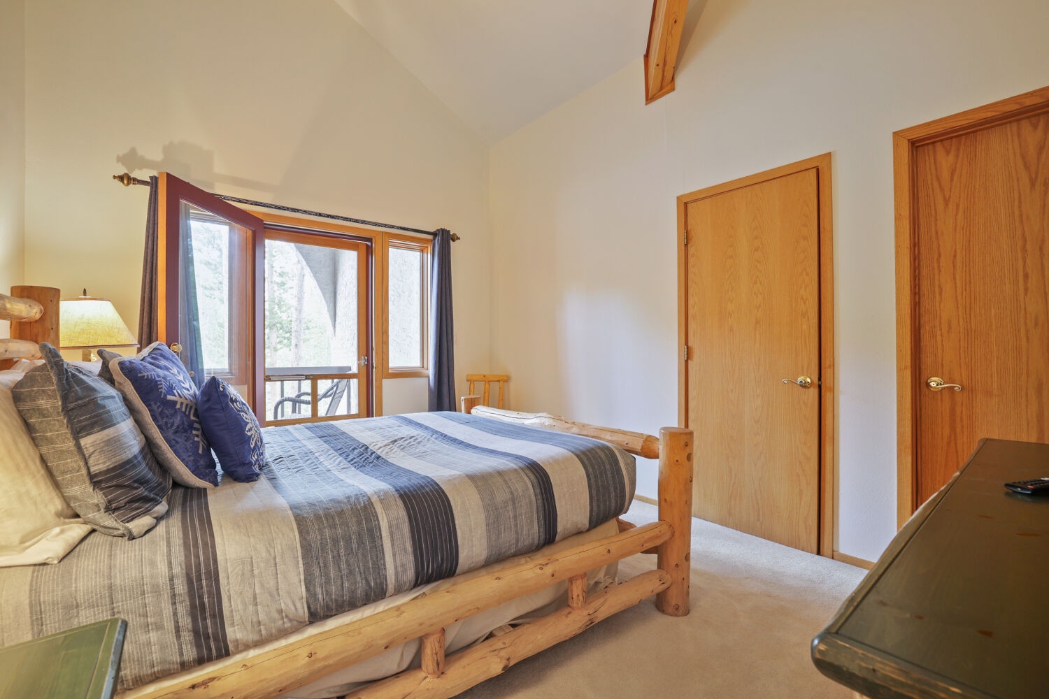Unwind in this cozy bedroom featuring a handcrafted log bed and views of nature through your own private windows. Rest easy in your mountain retreat.