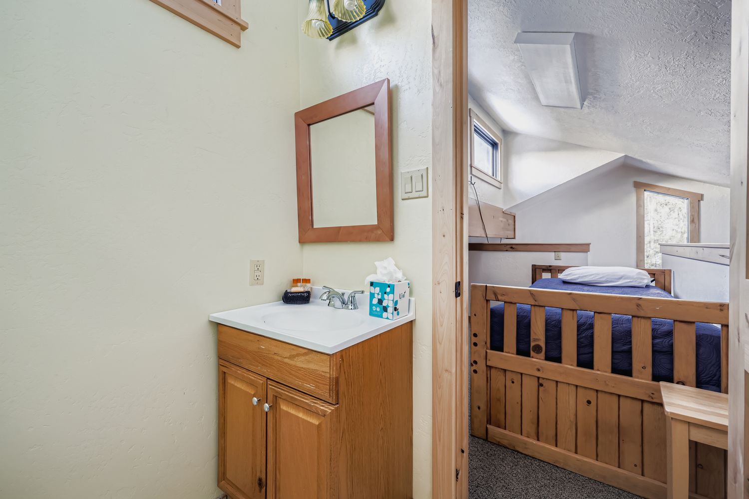 Your cozy bunk bed nook offers comfortable sleeping with a convenient vanity area right outside for easy morning routines.