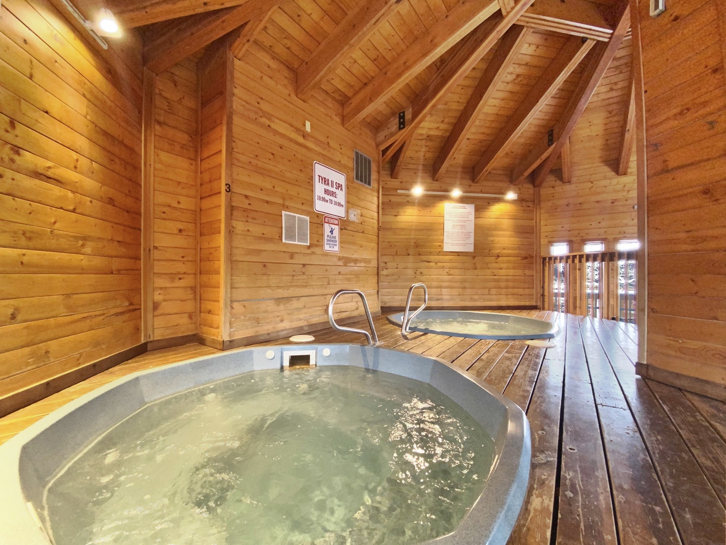Sink into bubbling warmth in this rustic wooden spa sanctuary, where timber beams create your perfect mountain retreat atmosphere.