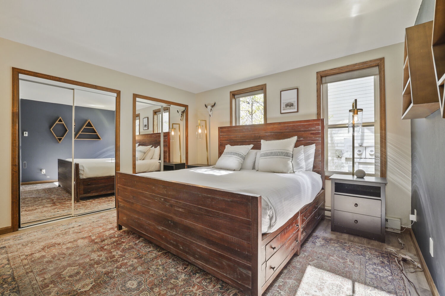 Sink into this cozy bedroom where warm wood tones and plush linens invite you to unwind. Natural light streams in, highlighting thoughtful touches and comfortable storage for all your belongings.