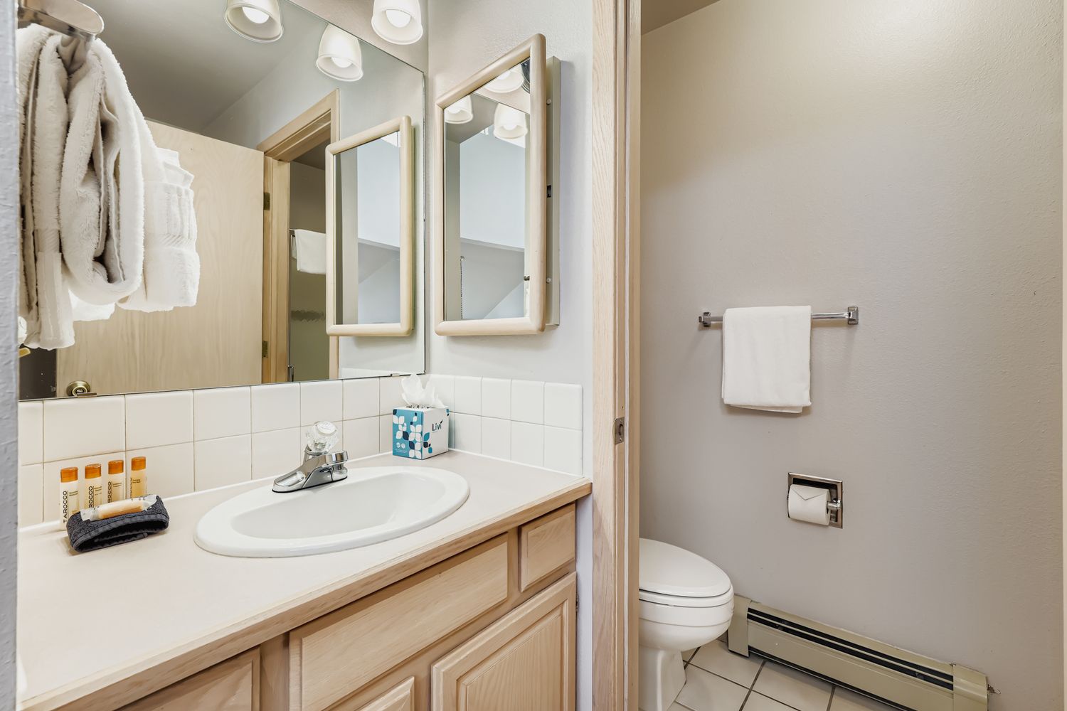Step into your well-appointed bathroom with modern vanity, fresh towels, and thoughtful amenities ready for your comfort.