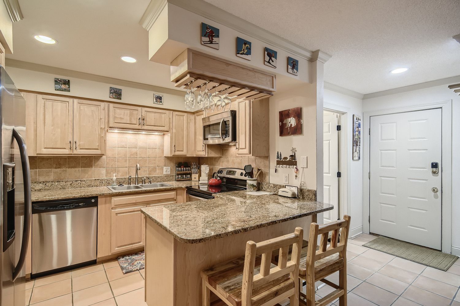 Your fully equipped kitchen features granite counters, modern appliances, and a cozy breakfast bar perfect for morning coffee or evening meals together.
