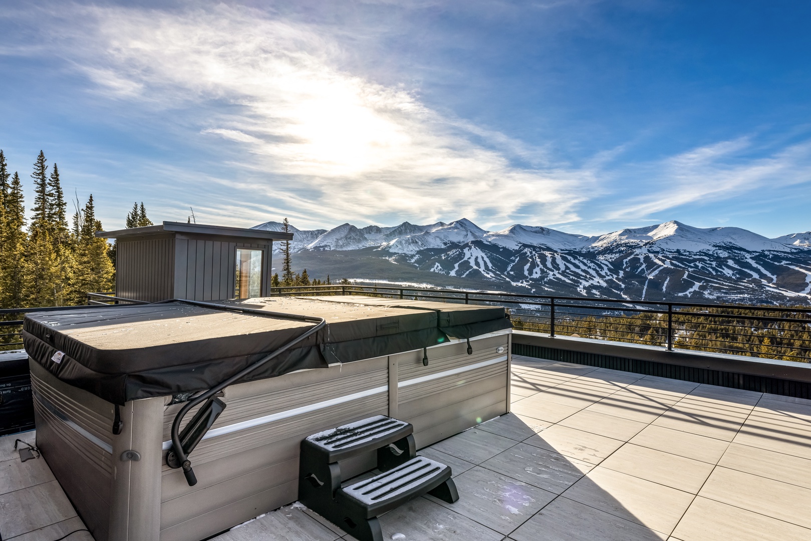 Soak in the hot tub while taking in breathtaking mountain vistas and pristine winter slopes.