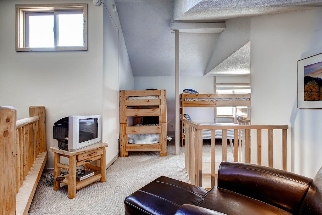 Your cozy loft features warm wood furnishings, comfortable leather seating, and entertainment options for relaxing evenings after mountain adventures.