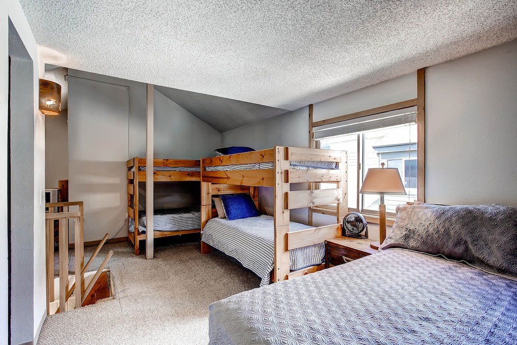 Your cozy retreat features comfortable bunk beds and a separate sleeping area, perfect for families or groups seeking a warm mountain getaway.