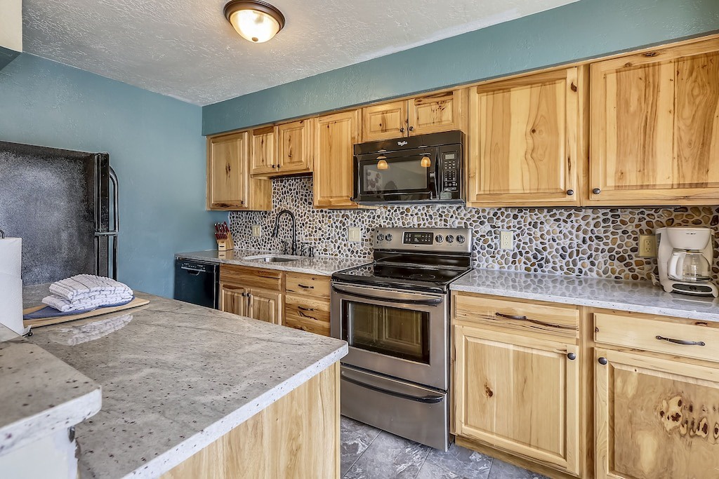 Your fully equipped kitchen features warm wood cabinets, modern appliances, and stylish stone countertops for memorable meal preparation.