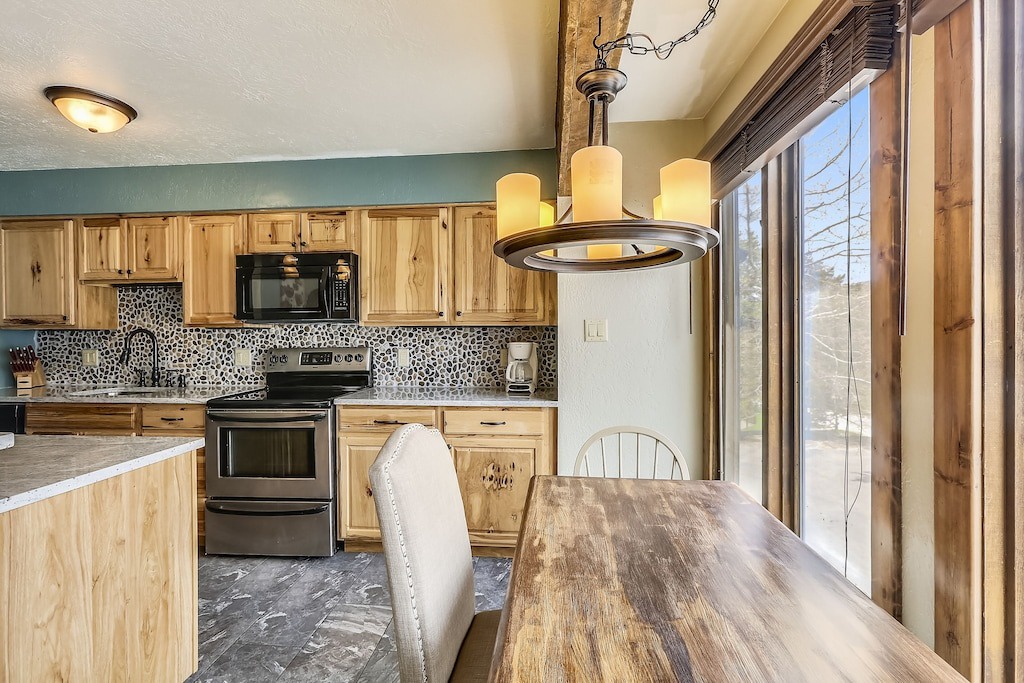 Cook your favorite meals in this warm rustic kitchen with modern appliances and natural light streaming through windows.
