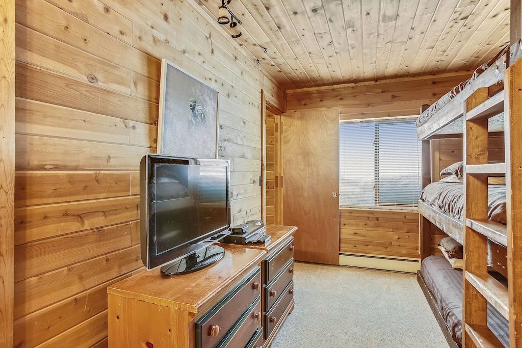Cozy wooden bunk room where you'll drift off surrounded by warm pine walls and rustic charm.