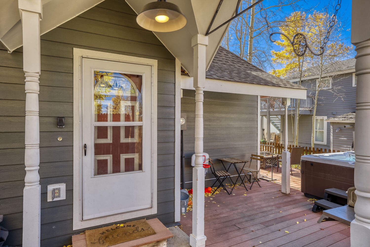 Step onto your covered deck and feel instantly at home—a cozy spot for morning coffee under the pendant light, plus your own private hot tub ready whenever you need to unwind.