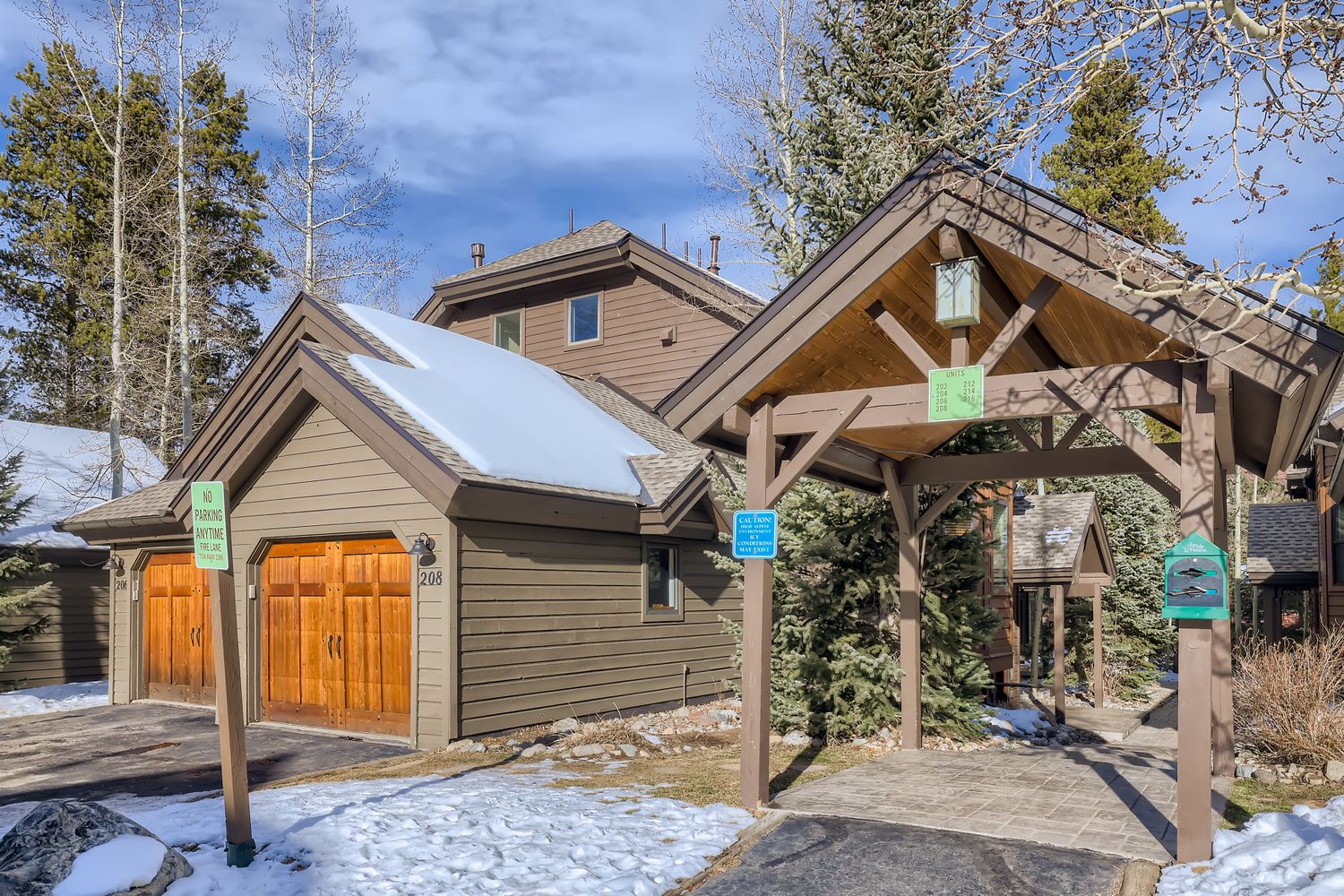 Welcome to your mountain retreat! This charming property offers rustic elegance with modern comfort, nestled among winter trees.