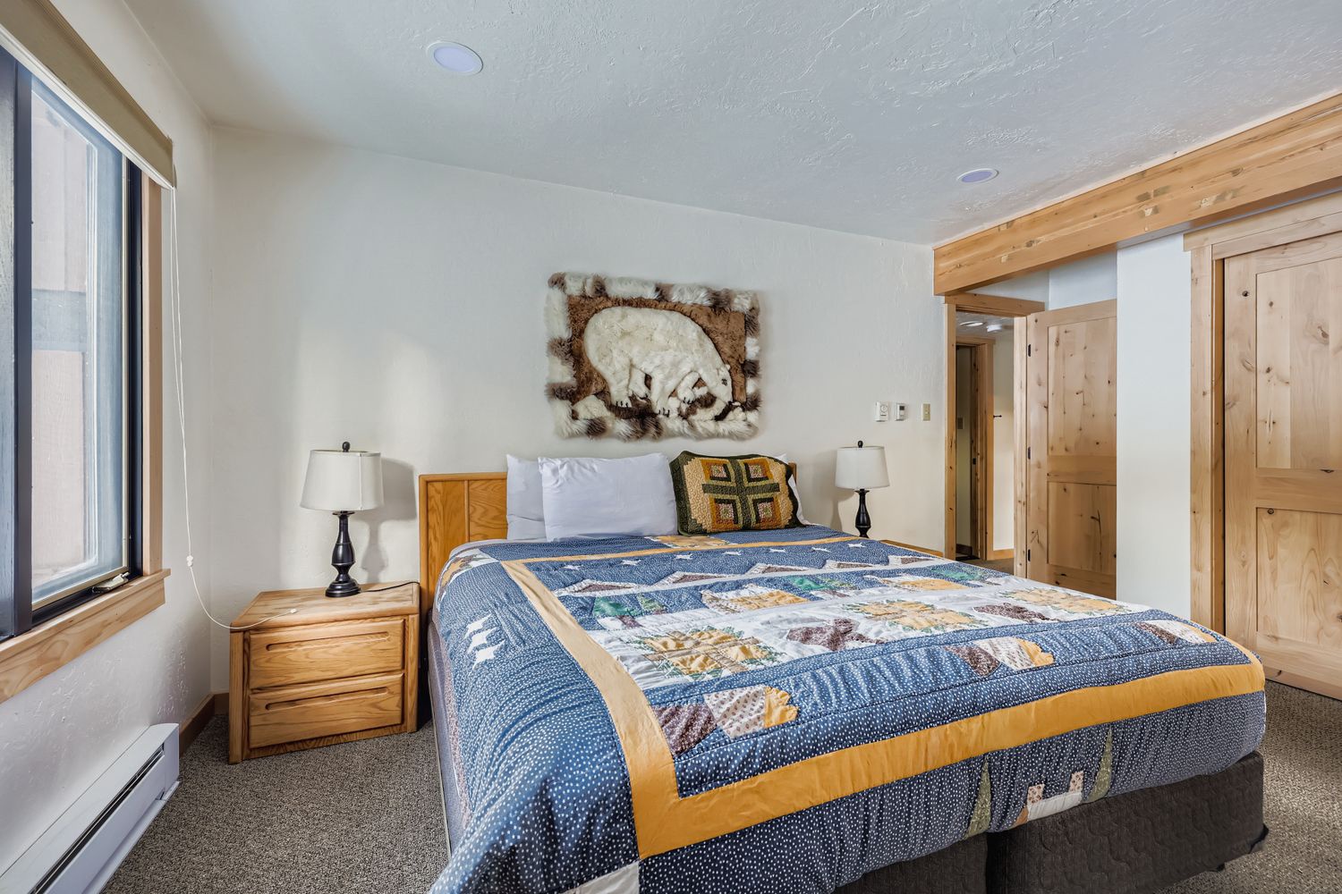 Rest peacefully in your cozy bedroom featuring rustic wood accents and handcrafted quilts that make this mountain retreat feel like home.